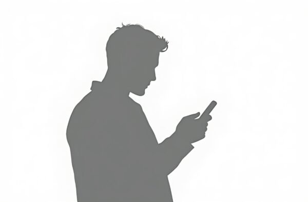 Silhouette of man using smartphone in profile.