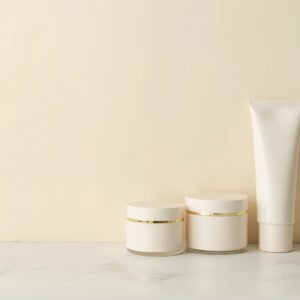 White cosmetic jar and tube bottle containers arranged on clean background with copy space