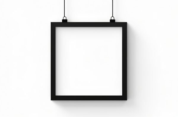 black picture frame hanging on a wall, isolated on white background