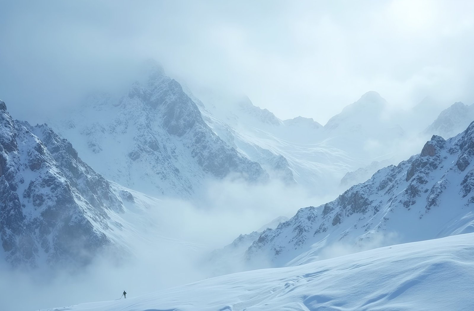 Snowstorm over snow-covered mountain peaks—ideal for winter weather, adventure and wilderness visuals