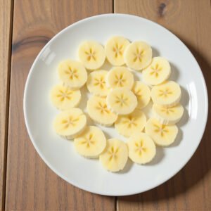 Banana slices on a white ceramic plate – snack or breakfast photo