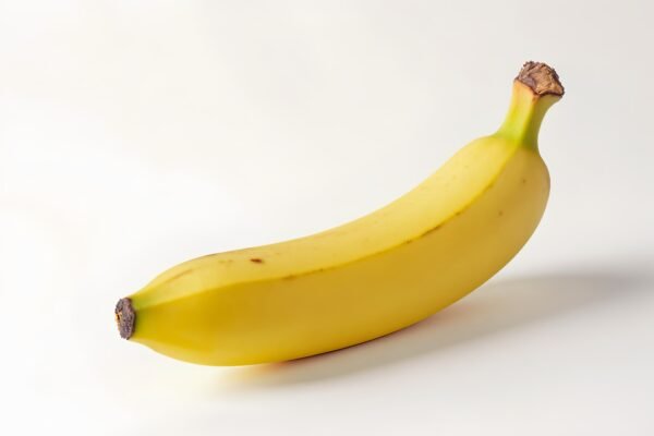 Photorealistic close-up of a fresh yellow banana on a white background