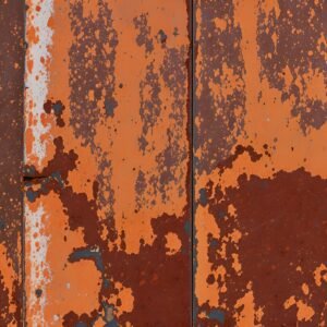 Grungy rusted metal wall showing heavy corrosion, peeling paint and texture—industrial background photo