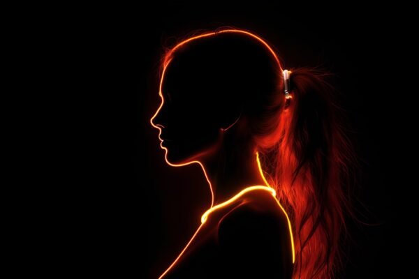 Woman silhouette illuminated by red and yellow neon light—ideal for creative, fashion, or digital art visuals