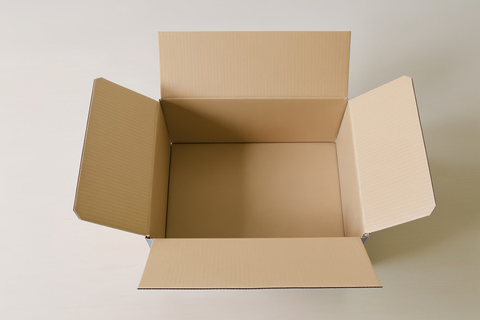 Open blank box mockup on a simple table, no labels, ready for branding