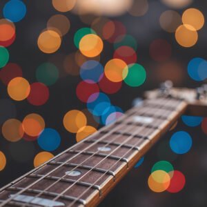 Guitar neck in sharp focus showing frets and strings detail for musical instrument photography