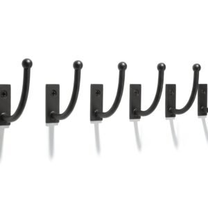 Black metal wall hooks row isolated on white background sharp shadows product style photography