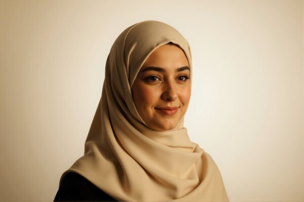 Middle Eastern woman with hijab soft smile warm lighting neutral background