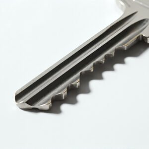 Realistic close up of silver key white background detailed grooves