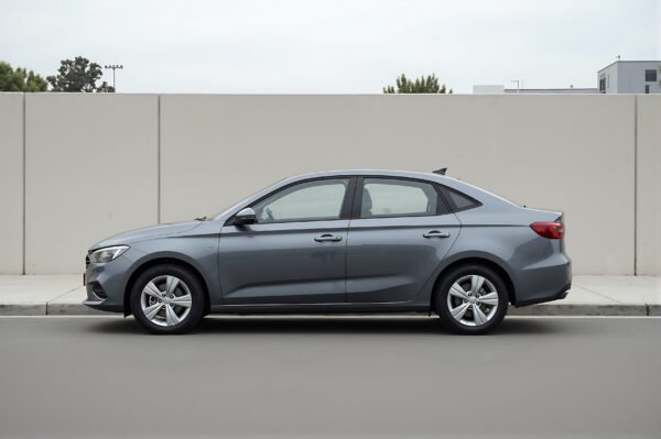 Realistic unbranded compact sedan parked on clean street neutral background no logos or markings soft daylight