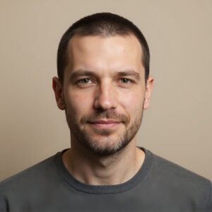 Studio portrait of a European man with short brown hair and light stubble neutral tone background realistic skin detail