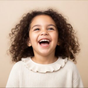 Studio portrait of a Latina child laughing high key lighting beige background lively energy