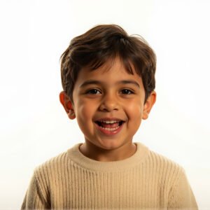 Studio portrait of a Middle Eastern boy with playful smile clean white background warm tone lighting