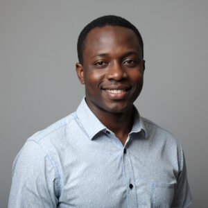 Studio portrait of an African man wearing casual shirt neutral gray background soft key lighting friendly expression