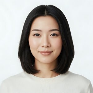 Studio portrait of an Asian woman with straight black hair clean white background subtle makeup calm expression