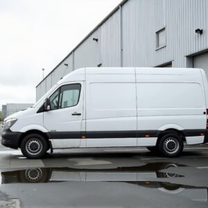 Unbranded delivery van parked beside warehouse white color no logos clean commercial design