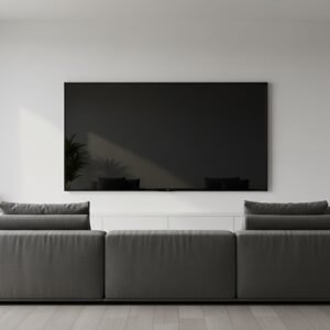 Wall mounted TV in minimalist room turned off reflective black screen no visible branding or manufacturer names or labels