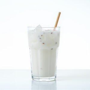Chilled coconut juice in a clear glass with water droplets bright studio light isolated on pure white for clean product style