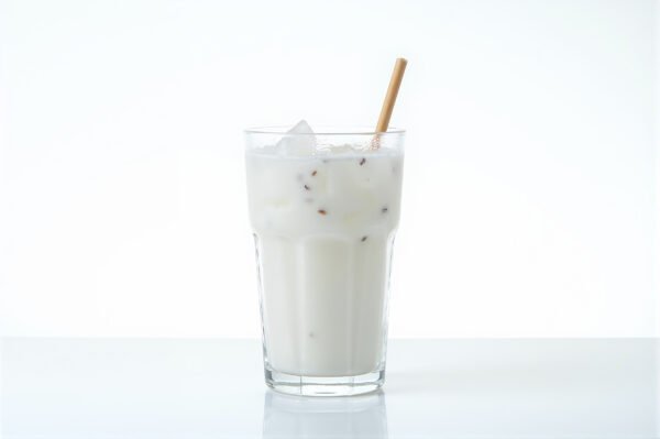 Chilled coconut juice in a clear glass with water droplets bright studio light isolated on pure white for clean product style
