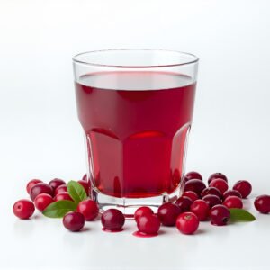 Deep red cranberry juice in a glass tumbler scattered fresh cranberries around base bright studio light pure white background