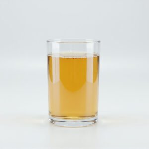 Glass filled with golden apple juice on a white background soft studio lighting realistic reflections no branding high resolution product photo
