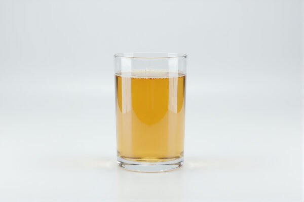 Glass filled with golden apple juice on a white background soft studio lighting realistic reflections no branding high resolution product photo