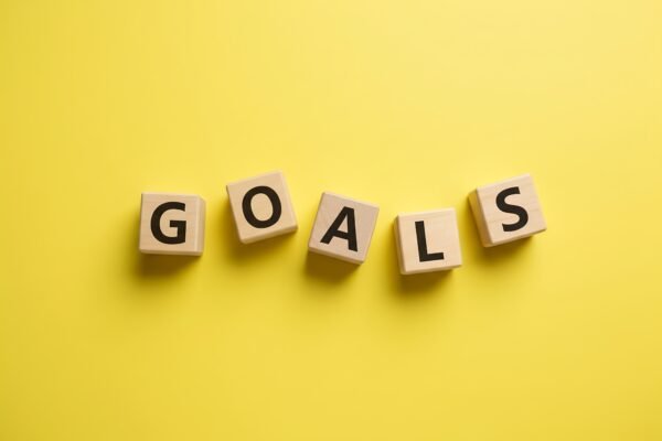 wooden letter cubes spelling goals not perfectly aligned some cubes angledople no logos no extra objectsspelling must be exact and clearly readable cG0pHSQP upscaled