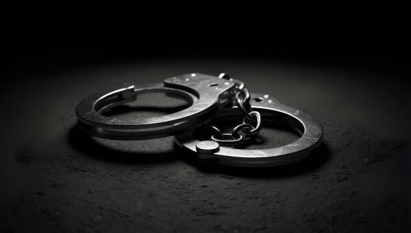 Download this ultra realistic metal handcuffs close-up photo with visible steel texture, ideal for legal blogs, crime themes, and documentary visuals.