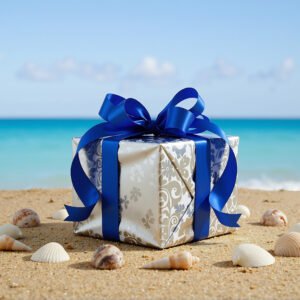 Download this wrapped birthday gift box photo on sandy beach with blue ribbon, perfect for summer celebration designs and greeting visuals.